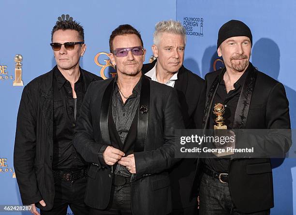 Musicians Larry Mullen Jr., Adam Clayton, Bono, and The Edge of U2 pose in the press room during the 71st Annual Golden Globe Awards held at The...