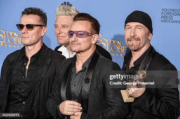 Musicians Larry Mullen Jr., Adam Clayton, Bono, and The Edge of U2 pose in the press room during the 71st Annual Golden Globe Awards held at The...