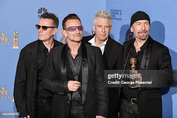 Musicians Larry Mullen Jr., Adam Clayton, Bono, and The Edge of U2 pose in the press room during the 71st Annual Golden Globe Awards held at The...