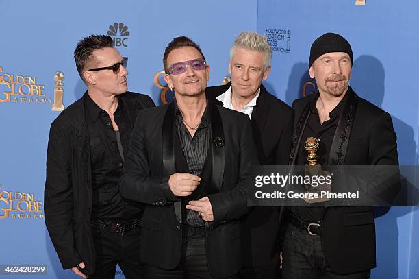 Musicians Larry Mullen Jr., Adam Clayton, Bono, and The Edge of U2 pose in the press room during the 71st Annual Golden Globe Awards held at The...