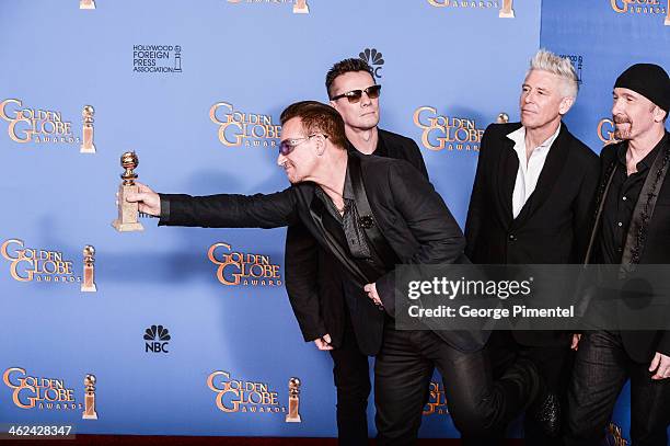 Musicians Larry Mullen Jr., Adam Clayton, Bono, and The Edge of U2 pose in the press room during the 71st Annual Golden Globe Awards held at The...