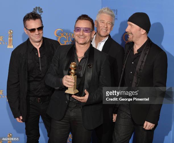 Musicians Larry Mullen Jr., Adam Clayton, Bono, and The Edge of U2 pose in the press room during the 71st Annual Golden Globe Awards held at The...