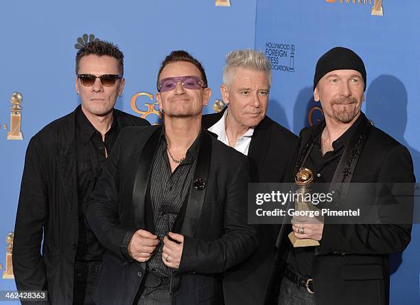 Musicians Larry Mullen Jr., Adam Clayton, Bono, and The Edge of U2 pose in the press room during the 71st Annual Golden Globe Awards held at The...