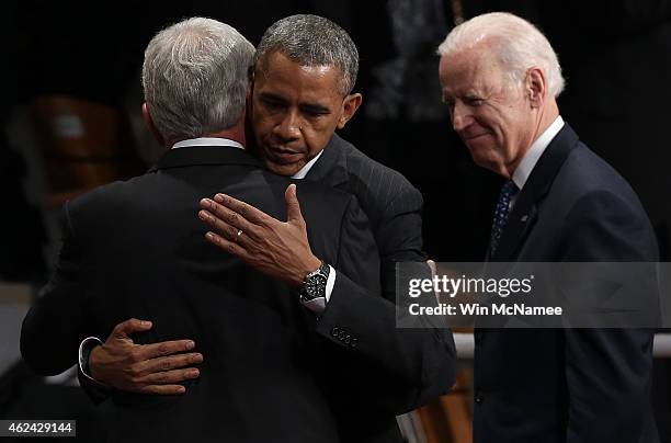 Secretary of Defense Chuck Hagel and U.S. President Barack Obama embrace as Vice President Joe Biden looks on during Hagel's farewell ceremony at...