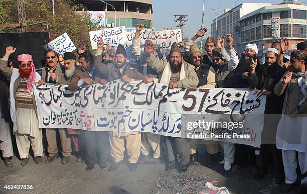 Pakistani religious activists from the World Pasban Khatam-e- Nabuat burning the flag of France during a protest against the printing of satirical...