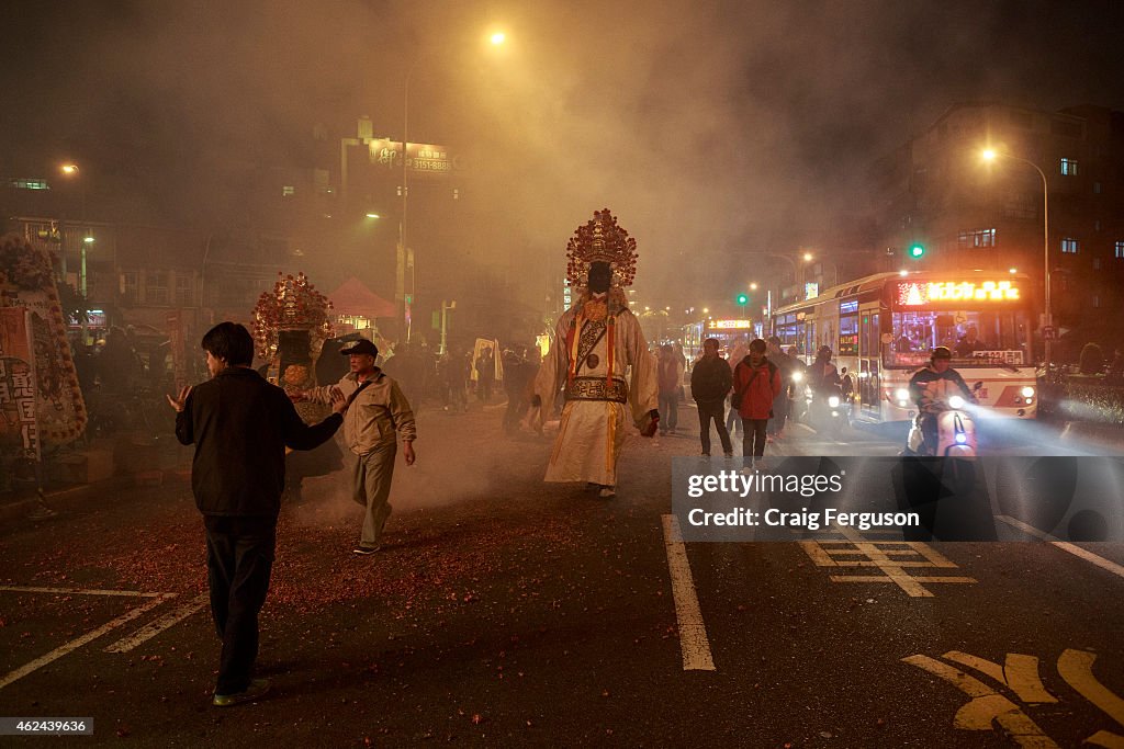 Walking gods move through the smoke created by thousands of...