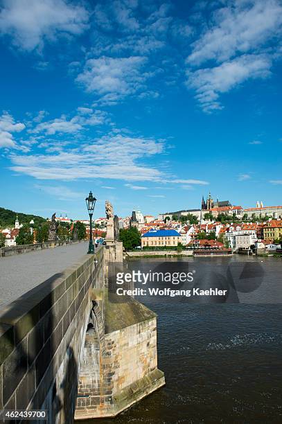 On the Charles Bridge in Prague, the capital and largest city of the Czech Republic, with Prague Castle in background.