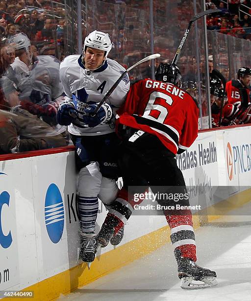 Andy Greene of the New Jersey Devils hits David Clarkson of the Toronto Maple Leafs during the third period at the Prudential Center on January 28,...