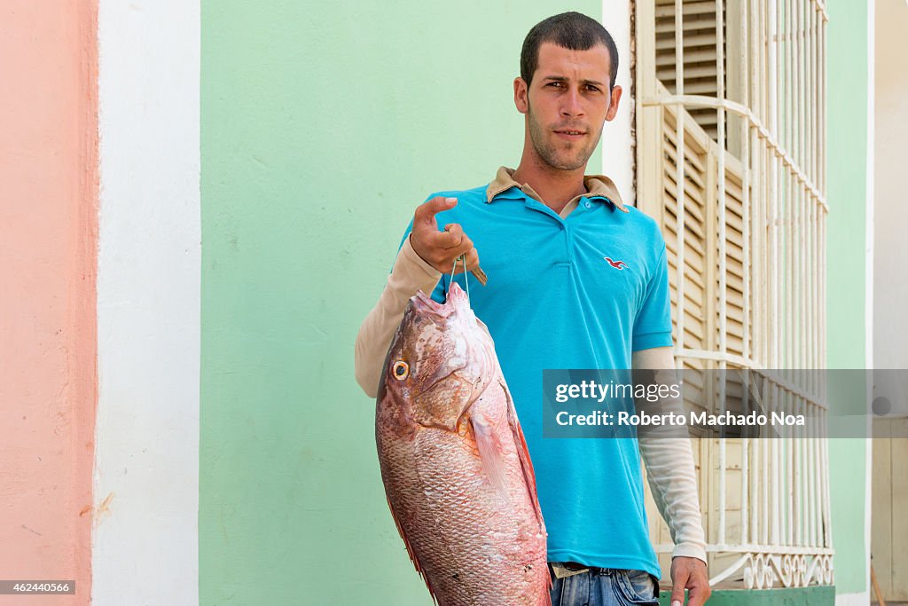 Cuban man selling his fish catch in the streets of Trinidad...