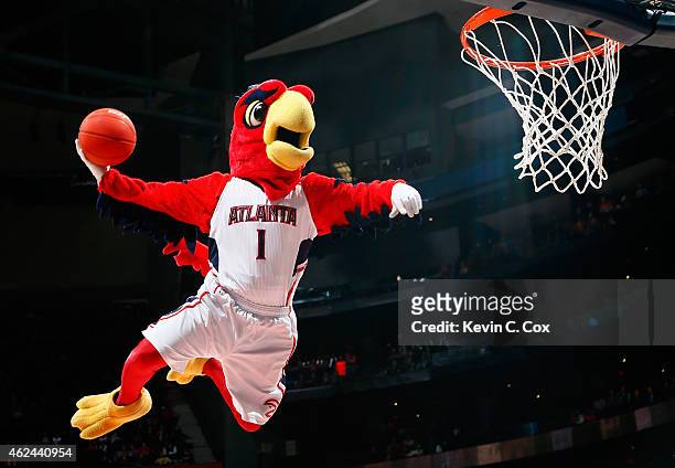 Harry the Hawk, mascot of the Atlanta Hawks, dunks during a timeout in the game between the Atlanta Hawks and the Brooklyn Nets at Philips Arena on...