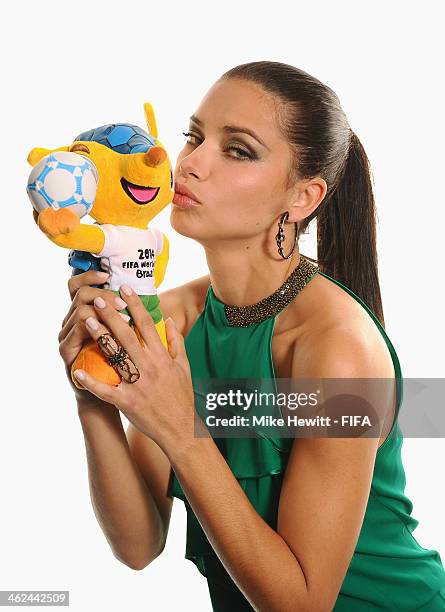 Model Adriana Lima poses for a portrait with Brazil's 2014 World Cup mascot Fuleco prior to the FIFA Ballon d'Or Gala 2013 at the Park Hyatt hotel on...