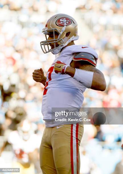 Colin Kaepernick of the San Francisco 49ers celebrates after a touchdown in the third quarter against the Carolina Panthers during the NFC Divisional...