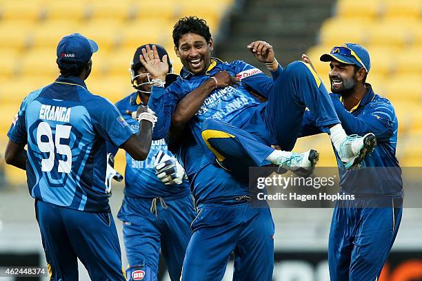 Tillakaratne Dilshan of Sri Lanka is congratulated by teammates Shaminda Eranga and Lahiru Thirimanne after taking the wicket of Kane Williamson of...