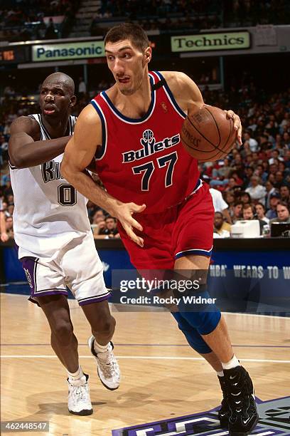 Gheorghe Muresan of the Washington Bullets dribbles the ball against the Sacramento Kings during a game played on December 16, 1996 at Arco Arena in...