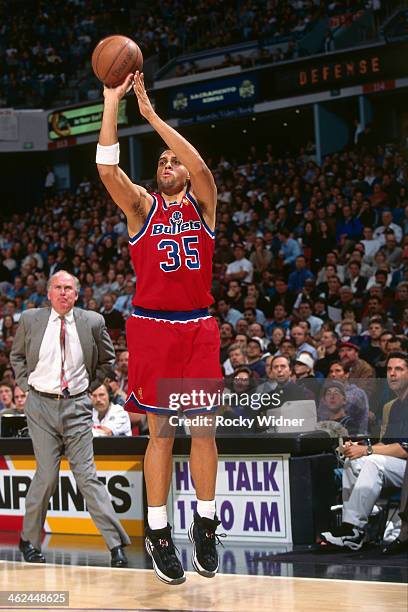 Tracy Murrary of the Washington Bullets shoots the ball against the Sacramento Kings during a game played on December 16, 1996 at Arco Arena in...