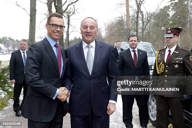 Finnish Prime Minister Alexander Stubb and Latvian President Andris Berzins shake hands as they meet at the Prime Minister's official residence...