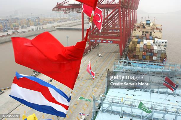 March 22: A Cosco container ship waits to be loaded with Cosco containers in Ningbo port on March 22, 2006 in Zhejiang province, China. Cosco stands...