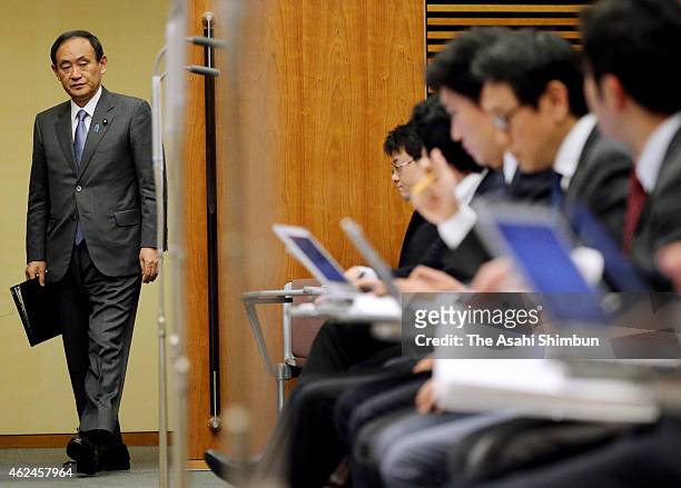 Japanese Chief Cabinet Secretary Yoshihide Suga enters a conference room at Prime Minister Shinzo Abe's official residence on January 29, 2015 in...