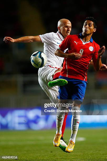 Juan Delgado of Chile fights for the ball with Michael Bradley of USA during an international friendly match between Chile and USA at El Teniente...