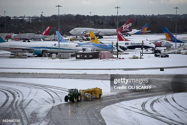 Snow is cleared from the aircraft taxiways at Manchester Airport as staff work to recommence flights, which had been suspended due to heavy snowfall,...