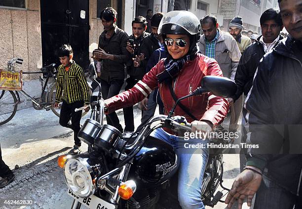 Bollywood actress and AAP leader Gul Panag rides bike during election campaign for the party candidate at Shashtri Nagar area for the upcoming Delhi...