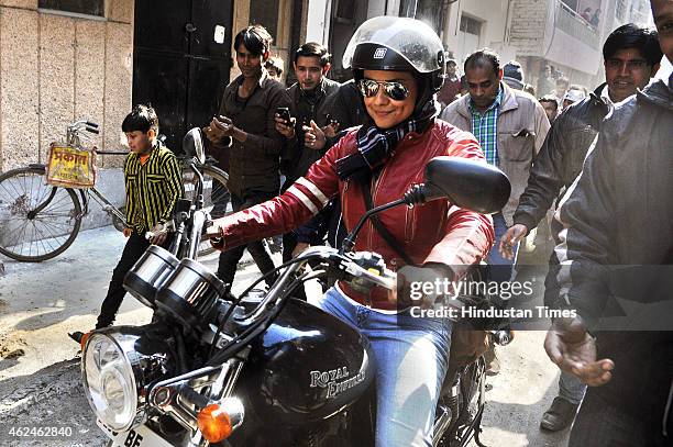 Bollywood actress and AAP leader Gul Panag rides bike during election campaign for the party candidate at Shashtri Nagar area for the upcoming Delhi...