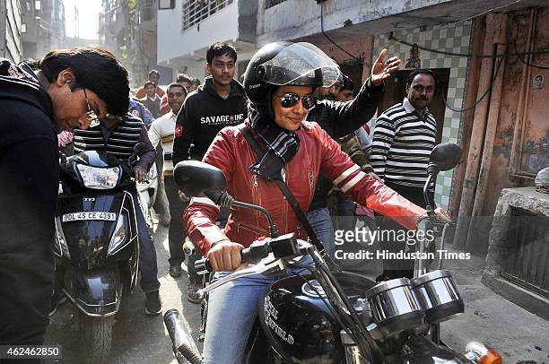 Bollywood actress and AAP leader Gul Panag rides bike during election campaign for the party candidate at Shashtri Nagar area for the upcoming Delhi...