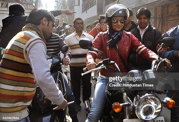 Bollywood actress and AAP leader Gul Panag rides bike during election campaign for the party candidate at Shashtri Nagar area for the upcoming Delhi...