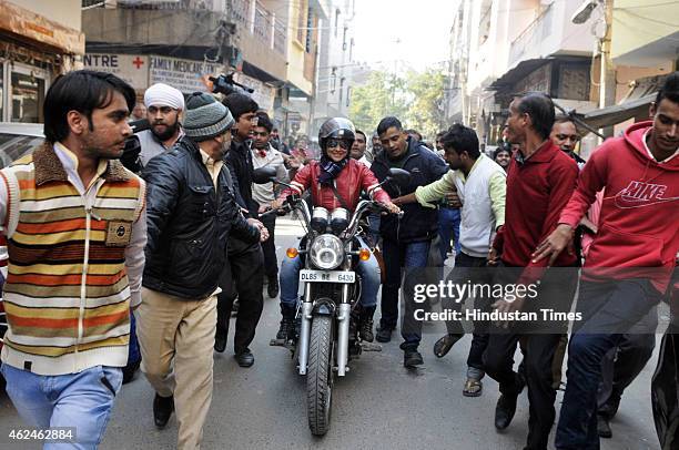 Bollywood actress and AAP leader Gul Panag rides bike during election campaign for the party candidate at Shashtri Nagar area for the upcoming Delhi...