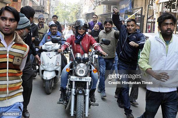 Bollywood actress and AAP leader Gul Panag rides bike during election campaign for the party candidate at Shashtri Nagar area for the upcoming Delhi...