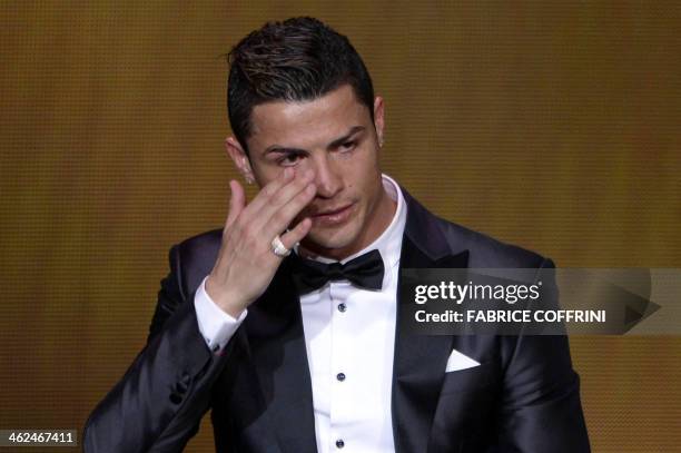 Real Madrid's Portuguese forward Cristiano Ronaldo cries after receiving the 2013 FIFA Ballon d'Or award for player of the year during the FIFA...