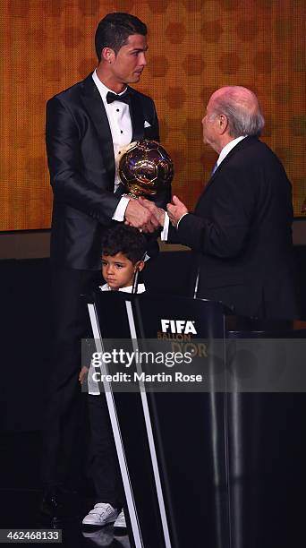 President Joseph S. Blatter hands over the award to Crisitano Ronaldo of Portugal during FIFA Ballon d'Or 2013 trophy at the Kongresshalle on January...
