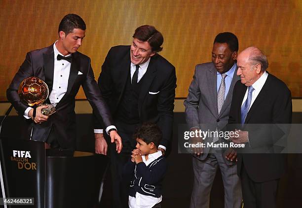 Crisitano Ronaldo of Portugal with his son Cristiano Ronaldo Jr receives the FIFA Ballon d'Or 2013 trophy at the Kongresshalle on January 13, 2014 in...