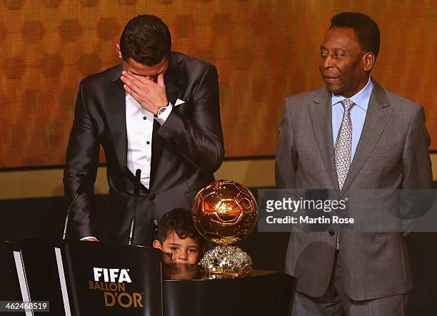 Crisitano Ronaldo of Portugal with his son Cristiano Ronaldo Jr receives the FIFA Ballon d'Or 2013 trophy at the Kongresshalle on January 13, 2014 in...