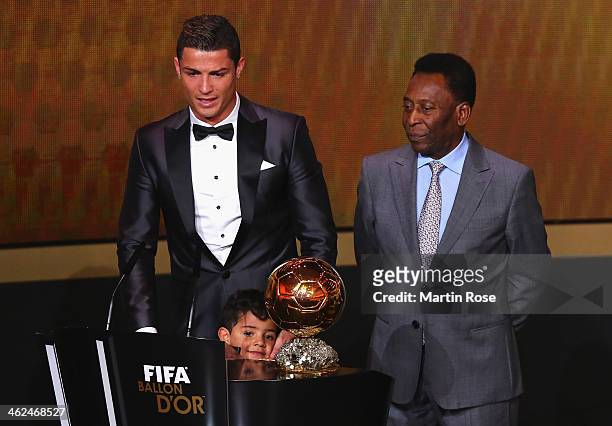 Crisitano Ronaldo of Portugal withh his son Cristiano Ronaldo Jr receives the FIFA Ballon d'Or 2013 trophy at the Kongresshalle on January 13, 2014...