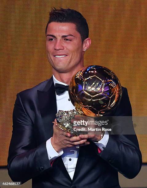 Crisitano Ronaldo of Portugal receives the FIFA Ballon d'Or 2013 trophy at the Kongresshalle on January 13, 2014 in Zurich, Switzerland.
