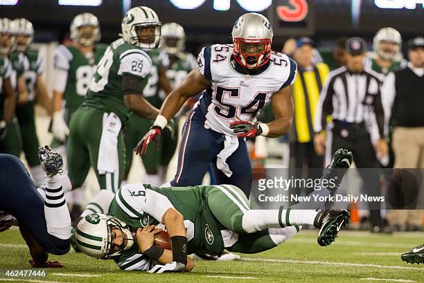 New York Jets against the New England Patriots at MetLife Stadium. Jets quarterback Mark Sanchez hits turf on a sack during the first half against...