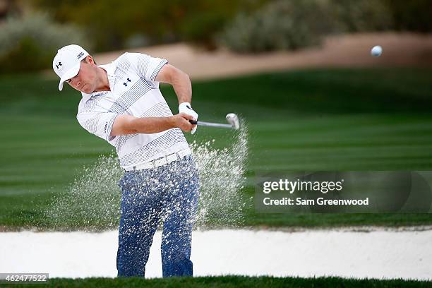 Jordan Spieth plays a shot out of a bunker on the second fairway during the first round of the Waste Management Phoenix Open at TPC Scottsdale on...