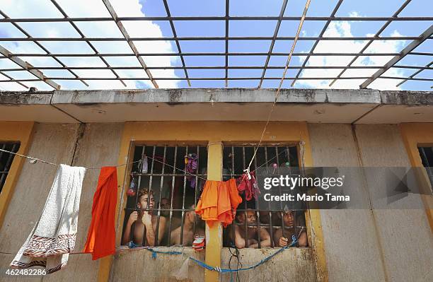 Inmates stand in their cell in the Pedrinhas Prison Complex, the largest penitentiary in Maranhao state, on January 27, 2015 in Sao Luis, Brazil....