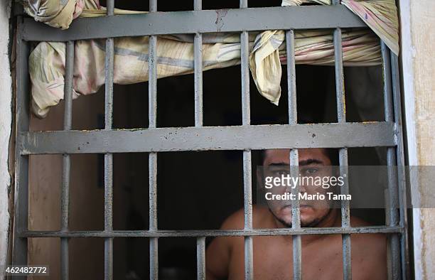 An inmate stand in his cell in the Pedrinhas Prison Complex, the largest penitentiary in Maranhao state, on January 27, 2015 in Sao Luis, Brazil....