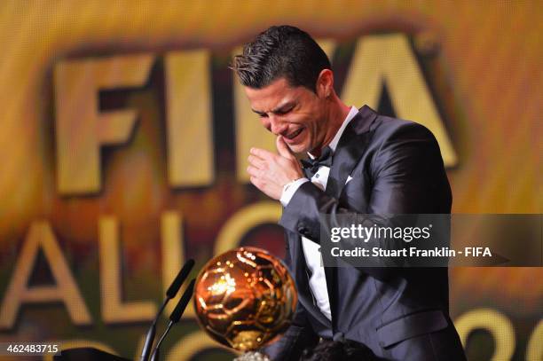 Ballon d'Or winner Cristiano Ronaldo of Portugal and Real Madrid gets emotional as he collects his award during the FIFA Ballon d'Or Gala 2013 at the...