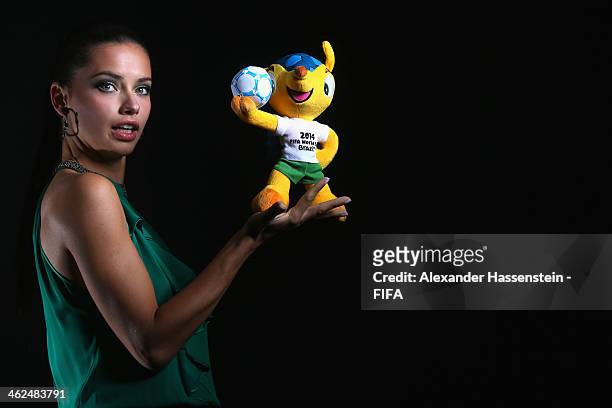 Model Adriana Lima poses for a portrait with Brazil's 2014 World Cup mascot Fuleco prior to the FIFA Ballon d'Or Gala 2013 at the Park Hyatt hotel on...