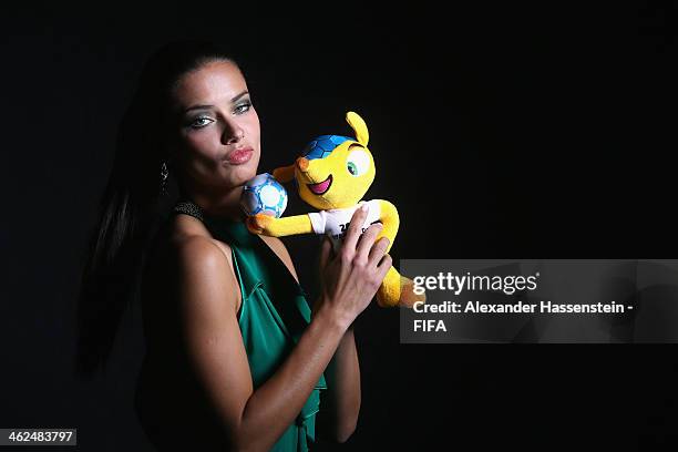 Model Adriana Lima poses for a portrait with Brazil's 2014 World Cup mascot Fuleco prior to the FIFA Ballon d'Or Gala 2013 at the Park Hyatt hotel on...