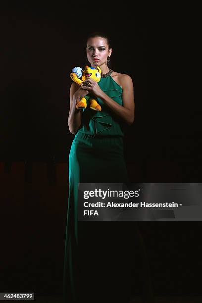 Model Adriana Lima poses for a portrait with Brazil's 2014 World Cup mascot Fuleco prior to the FIFA Ballon d'Or Gala 2013 at the Park Hyatt hotel on...