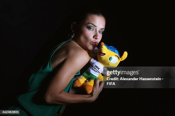 Model Adriana Lima poses for a portrait with Brazil's 2014 World Cup mascot Fuleco prior to the FIFA Ballon d'Or Gala 2013 at the Park Hyatt hotel on...