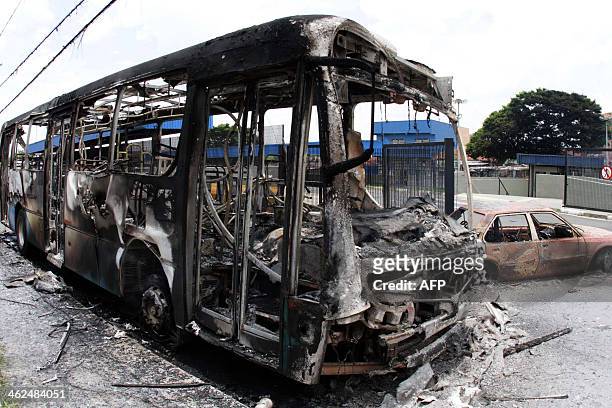 View of a burnt bus and car at Vida Nova bus station, in Campinas, some 96 km from Sao Paulo, Brazil on January 13, 2013. People torched buses and...