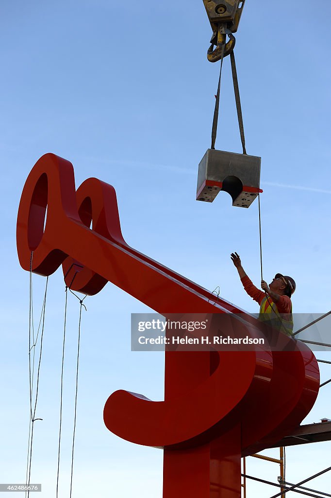 Workers install "Lola" a new public art piece at Union Station in Denver, CO.