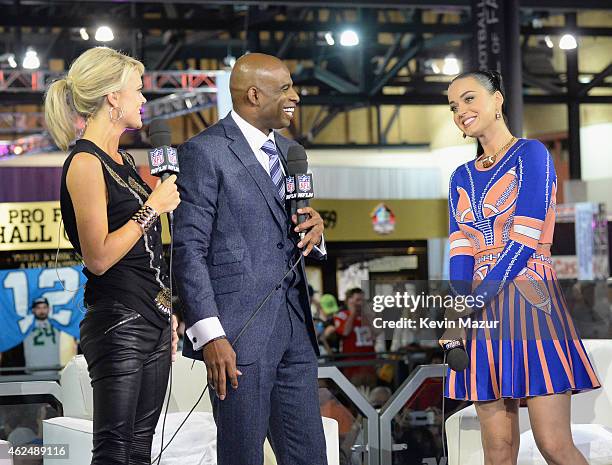 Recording artist Katy Perry is interviewed by sportscaster Melissa Stark and former NFL player and sports analyst Deion Sanders at the NFL Experience...