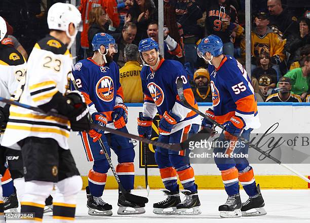 Michael Grabner of the New York Islanders is congratulated by teammates Johnny Boychuk and Nick Leddy after scoring a second period goal against the...