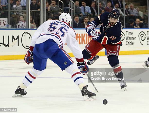 Derick Brassard of the New York Rangers takes the shot against Sergei Gonchar of the Montreal Canadiens at Madison Square Garden on January 29, 2015...